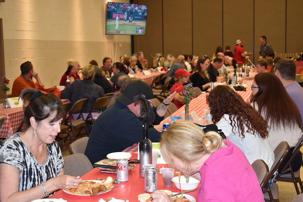 Members of the community eating and chatting at the Spaghetti Dinner